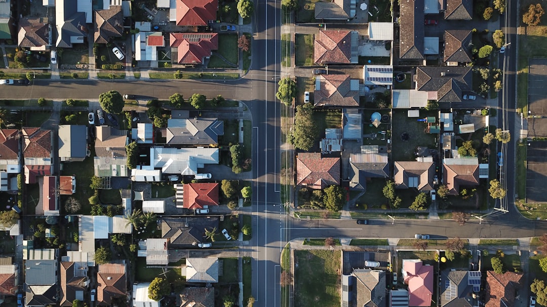A row of suburban houses with front lawns on a residential street